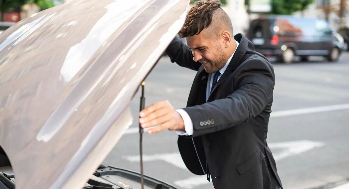 hombre revisando el sistema de encendido de su auto
